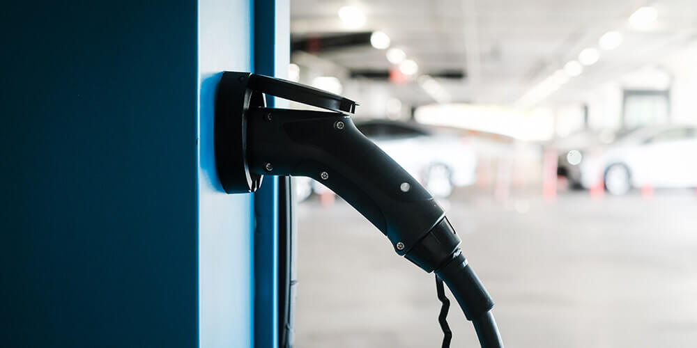A commercial EV charging station installed in a parking garage. 