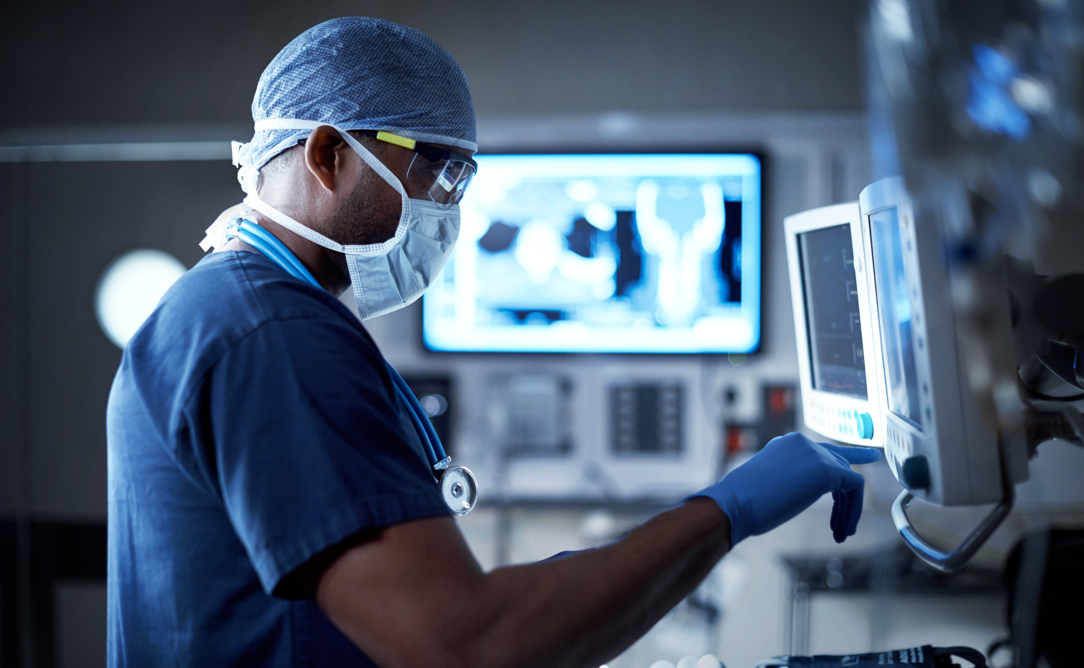 doctor checking patient vitals on a monitor