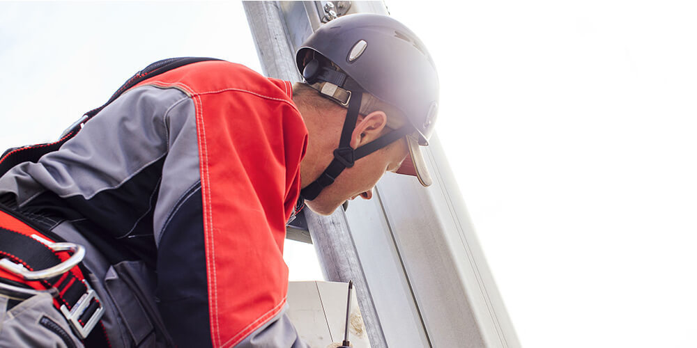 A cell tower technician conducting tower and cell site maintenance.   