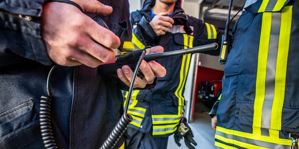 A first responder using an Emergency Responder Radio Communication System (ERRCS). 