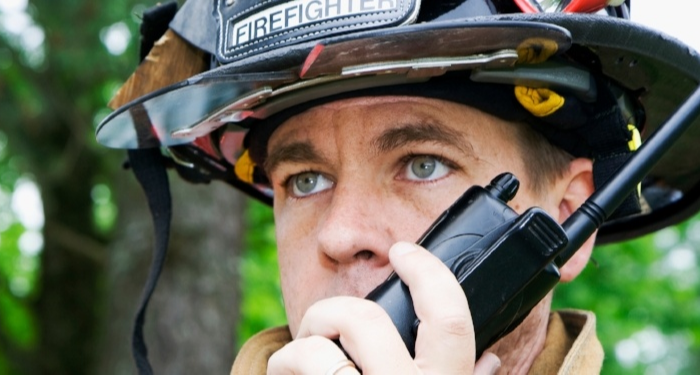 First responder using a radio that's connected to a public safety DAS. 