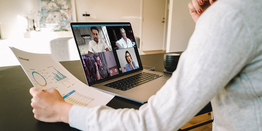 woman using a laptop for a video conference while working from home.